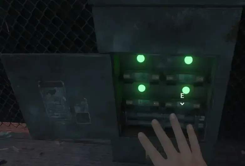 An open central fuse panel with four green status lights and a hand near its controls.