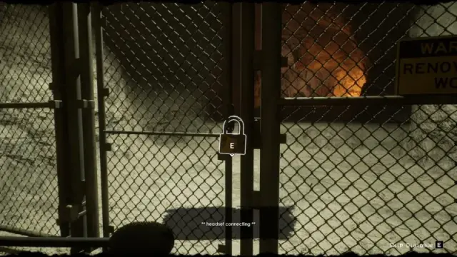 The locked chain-link gate and its padlock interaction in the caverns.